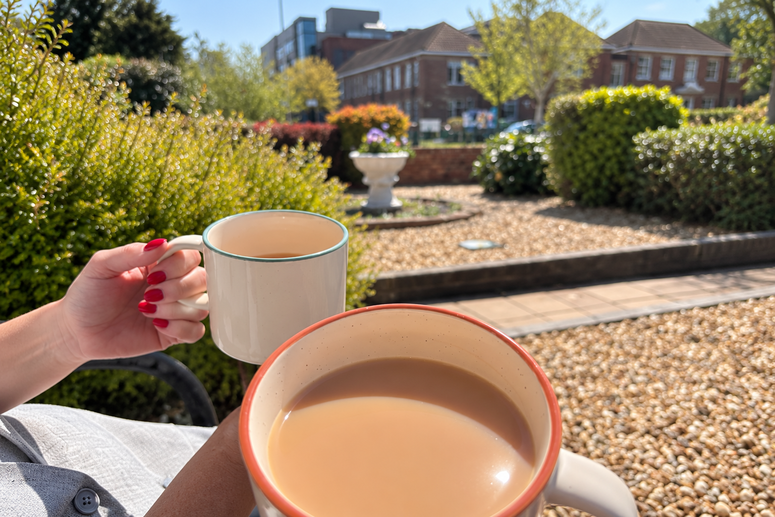 Two mugs of tea in the sunshine outside Hope Funeral Care