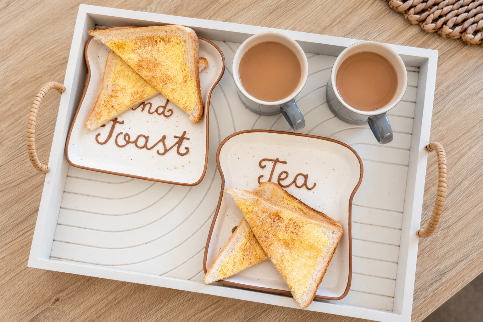 Two cups of tea and toast on a tray, ready for a quiet conversation