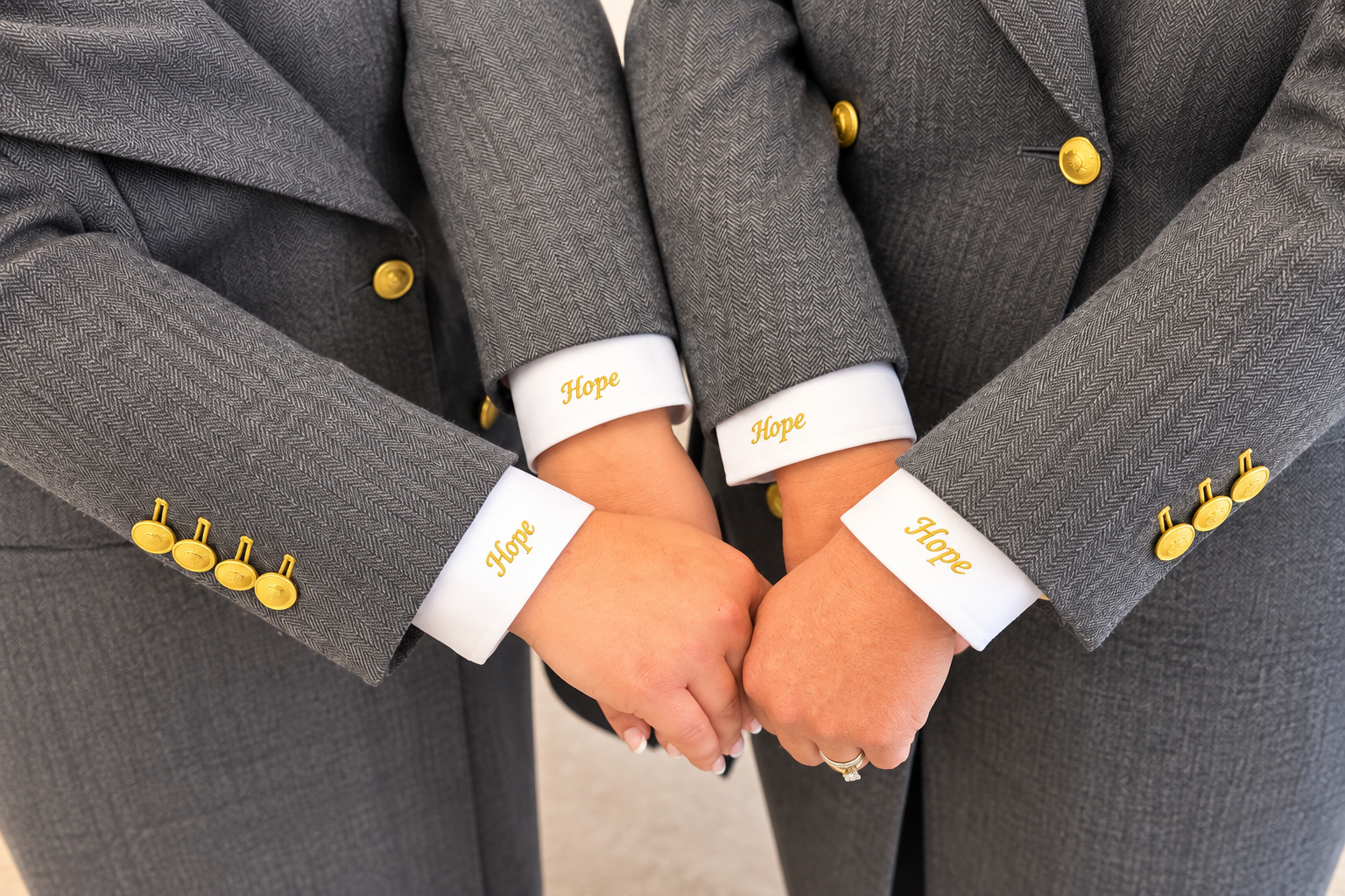 Folded hands with Hope embroidered uniform cuffs